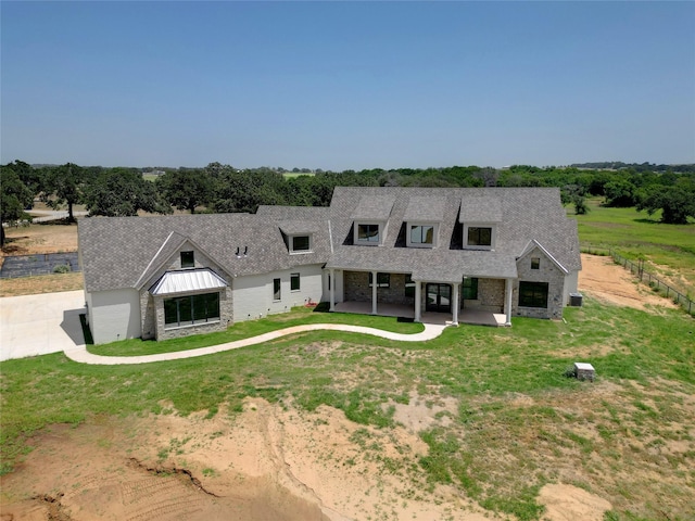 view of front facade with a front lawn and a patio area