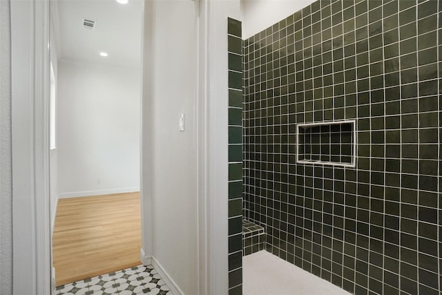 bathroom with tiled shower