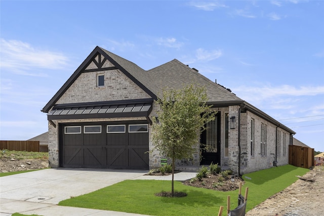 view of front of home featuring a garage and a front yard