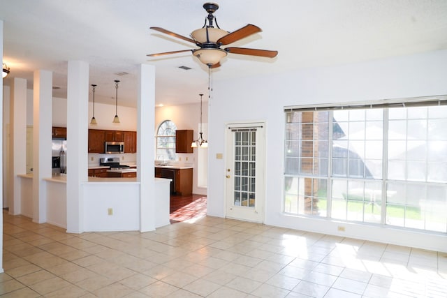 kitchen with pendant lighting, ceiling fan, light tile patterned floors, and stainless steel appliances