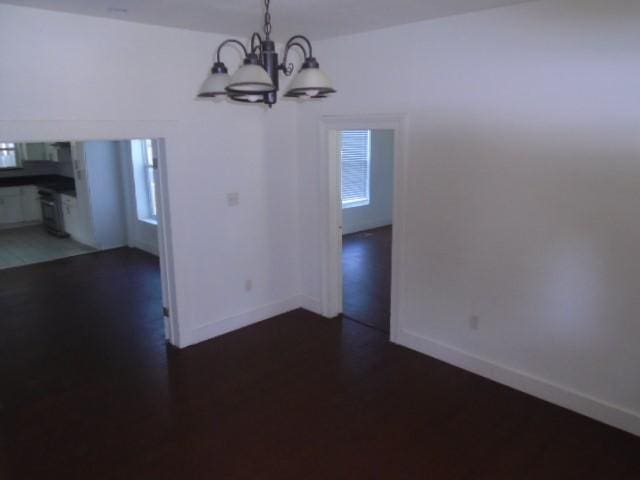 unfurnished dining area with a notable chandelier and a healthy amount of sunlight