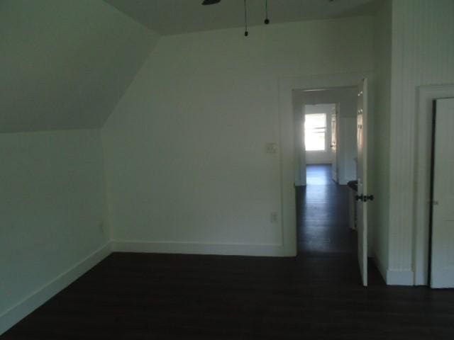 bonus room with vaulted ceiling, dark hardwood / wood-style floors, and ceiling fan