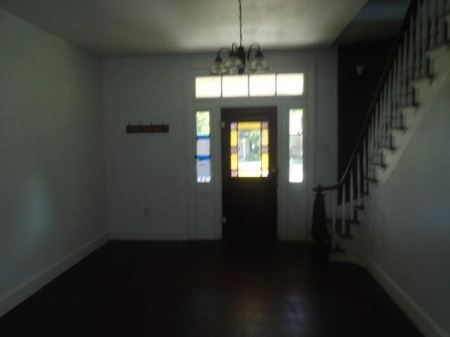 foyer entrance with a notable chandelier