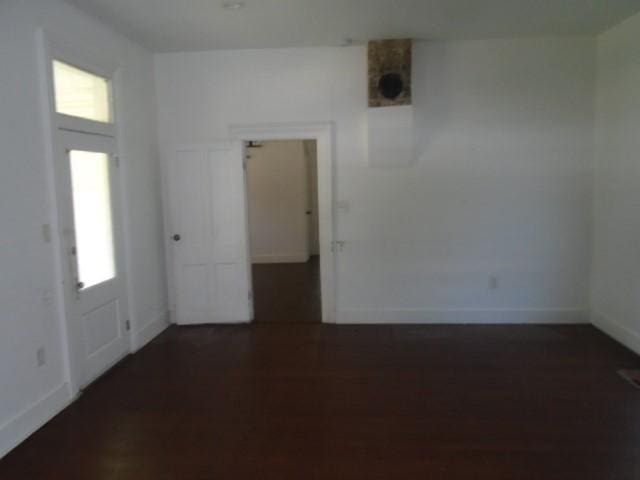 unfurnished room with a healthy amount of sunlight and dark hardwood / wood-style flooring