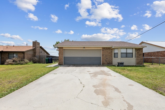 ranch-style house featuring a garage and a front lawn