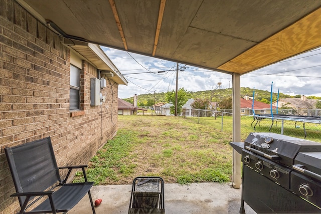 view of yard with a patio and a trampoline