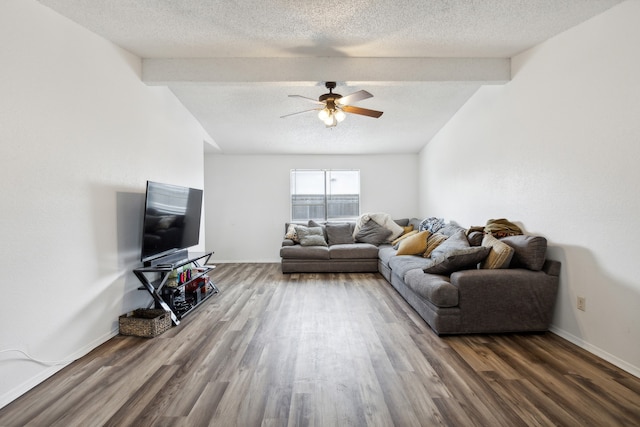 living room with vaulted ceiling with beams, ceiling fan, a textured ceiling, and hardwood / wood-style flooring