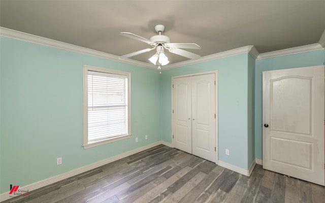 unfurnished bedroom with ceiling fan, wood-type flooring, ornamental molding, and a closet