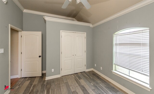 unfurnished bedroom featuring a closet, hardwood / wood-style flooring, vaulted ceiling, ceiling fan, and ornamental molding