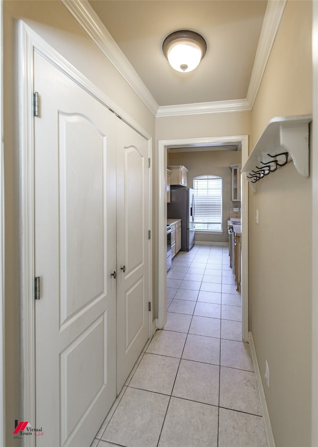 corridor featuring crown molding and light tile patterned floors