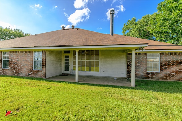 rear view of house featuring a patio area and a lawn