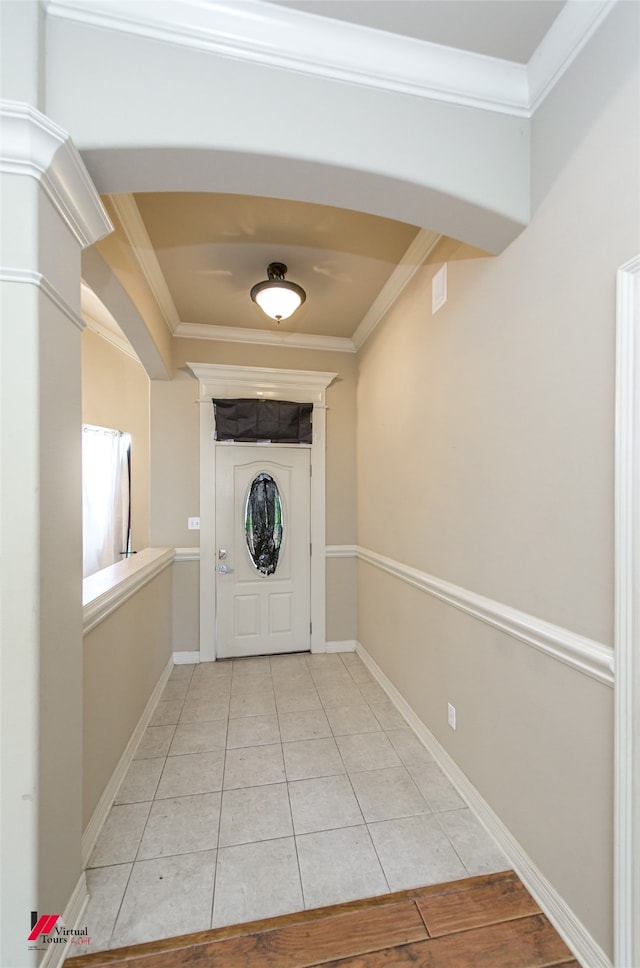 tiled foyer with ornamental molding