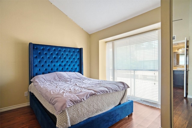 bedroom featuring lofted ceiling and dark hardwood / wood-style floors