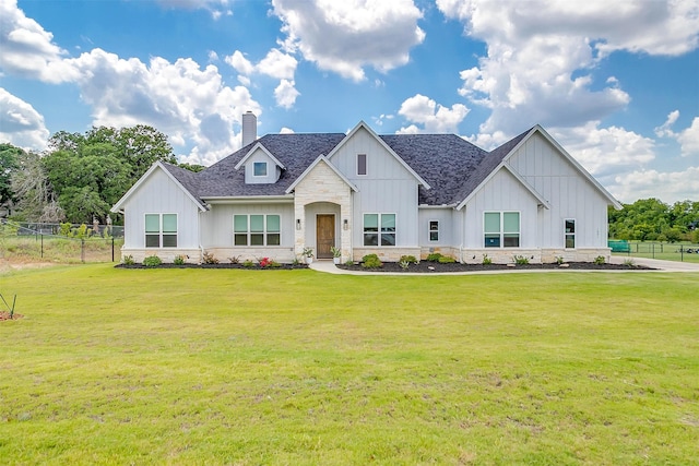 modern farmhouse style home featuring a front yard