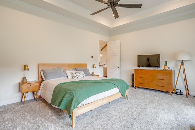 carpeted bedroom featuring a tray ceiling, ornamental molding, and ceiling fan