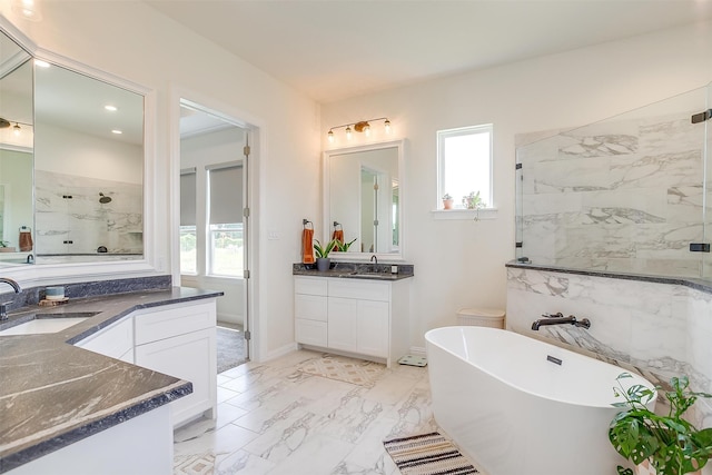 bathroom with vanity and shower with separate bathtub