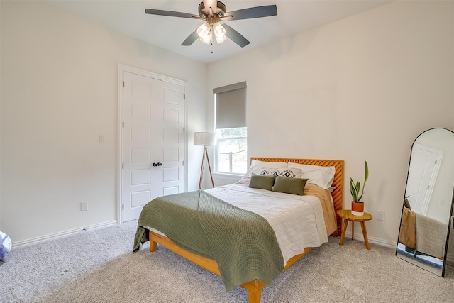 bedroom with a closet, ceiling fan, and carpet flooring