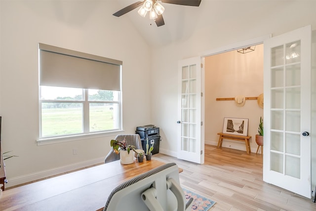 home office with french doors, light hardwood / wood-style floors, vaulted ceiling, and ceiling fan