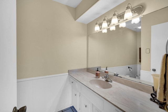 bathroom featuring vanity and toilet