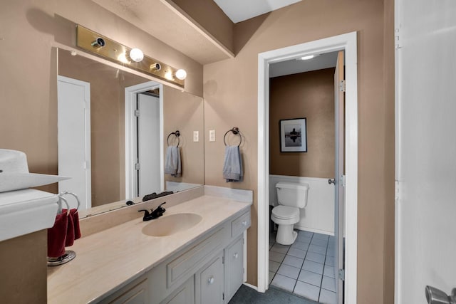 bathroom featuring vanity, toilet, and tile patterned flooring