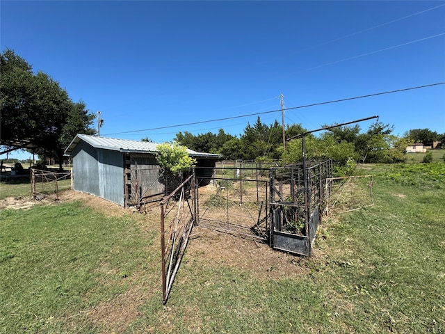 view of yard featuring an outbuilding and a rural view