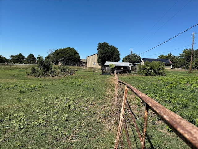 view of yard featuring an outbuilding and a rural view