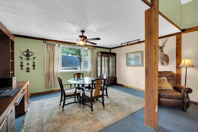 dining area featuring ceiling fan, ornamental molding, light carpet, and a textured ceiling