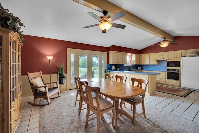 dining space featuring french doors, sink, lofted ceiling with beams, light tile patterned floors, and ceiling fan