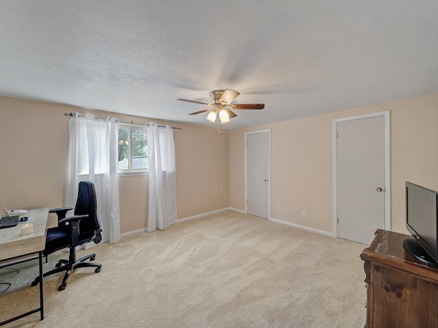 carpeted office with ceiling fan and a textured ceiling