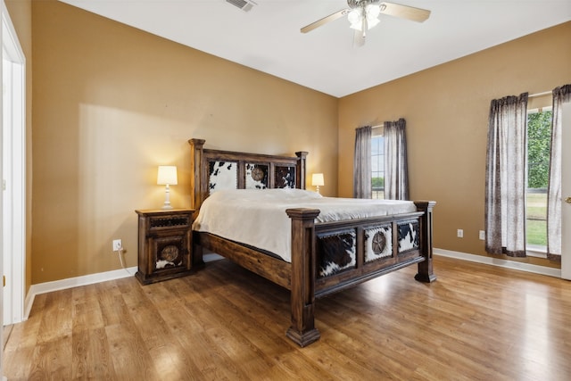 bedroom with light hardwood / wood-style flooring and ceiling fan