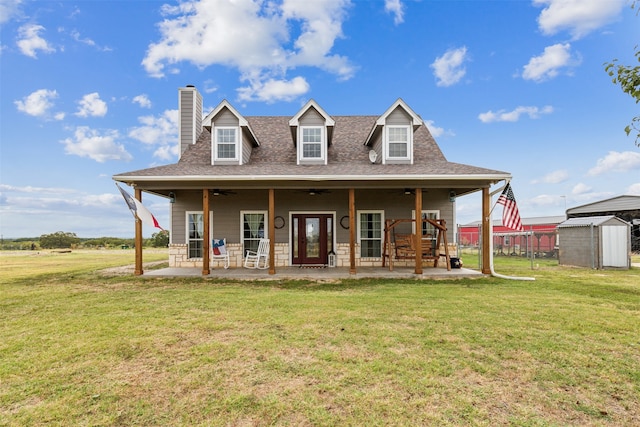 rear view of house featuring a patio area, a storage shed, a yard, and ceiling fan