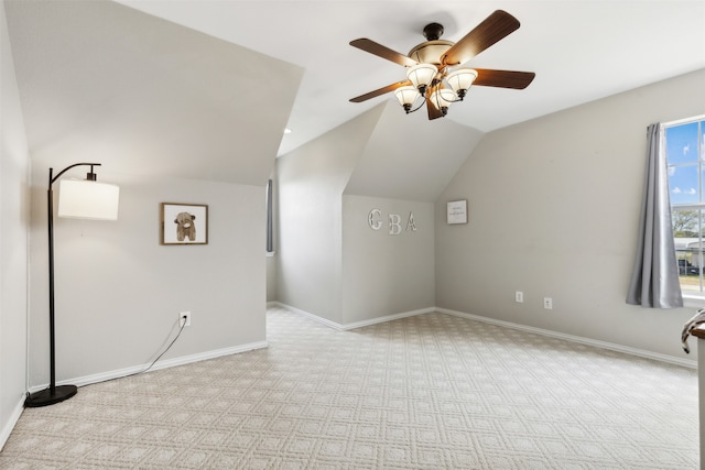 bonus room with ceiling fan, vaulted ceiling, and light colored carpet