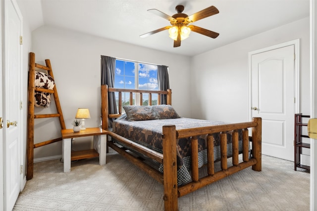 carpeted bedroom featuring vaulted ceiling and ceiling fan