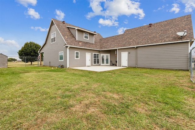 rear view of property with a patio and a lawn