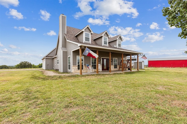 view of front of property featuring a front lawn and an outdoor structure