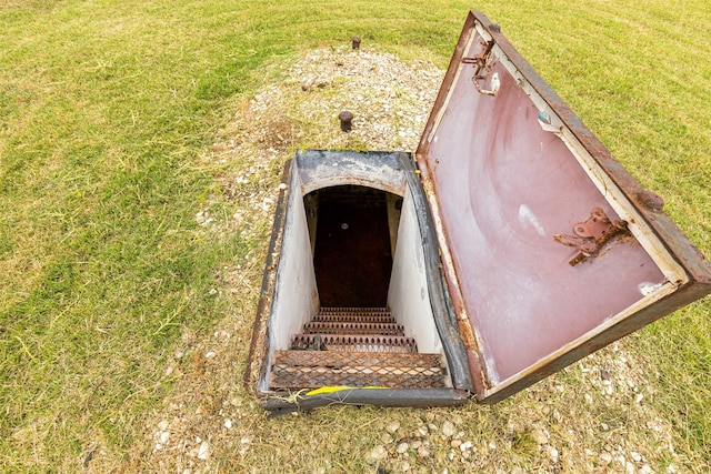 view of storm shelter featuring a yard