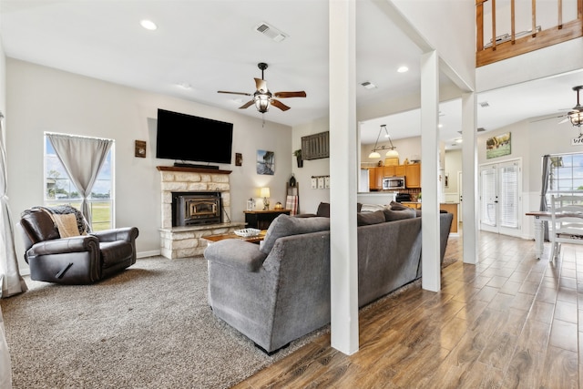 living room featuring ceiling fan, hardwood / wood-style flooring, and plenty of natural light