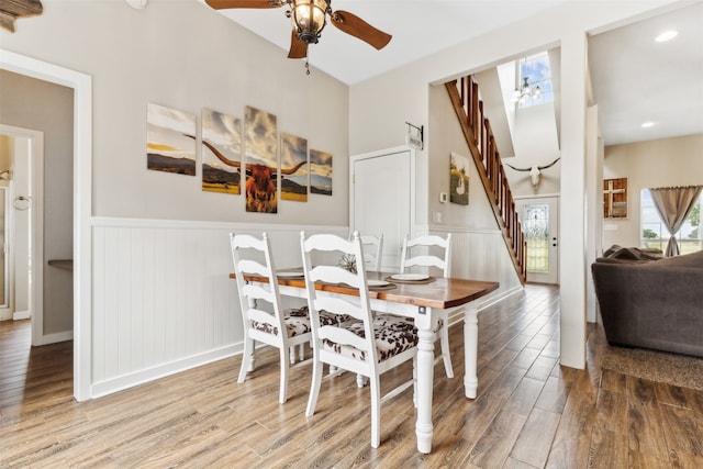 dining area with hardwood / wood-style floors and ceiling fan