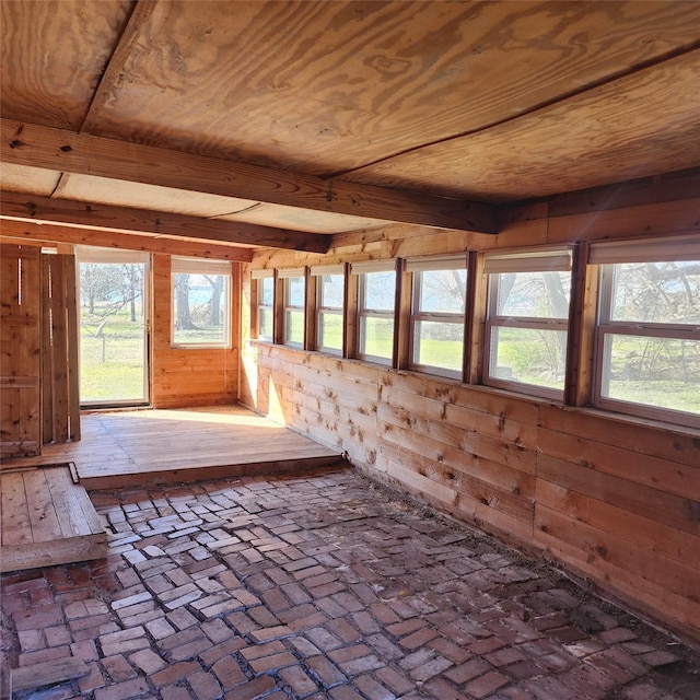 unfurnished sunroom with beamed ceiling and wood ceiling