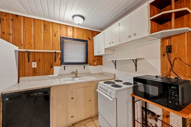 kitchen with sink, black appliances, wood ceiling, white cabinets, and wooden walls