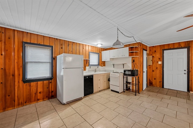 kitchen with black appliances, sink, wood walls, ceiling fan, and white cabinetry