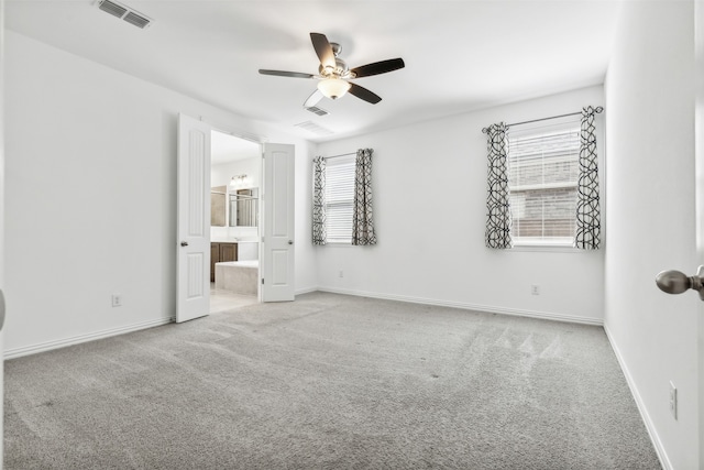 unfurnished room with plenty of natural light, ceiling fan, and light colored carpet