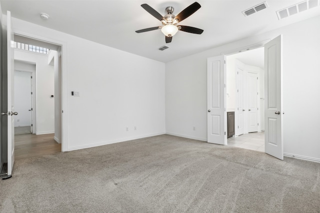 carpeted spare room with ceiling fan