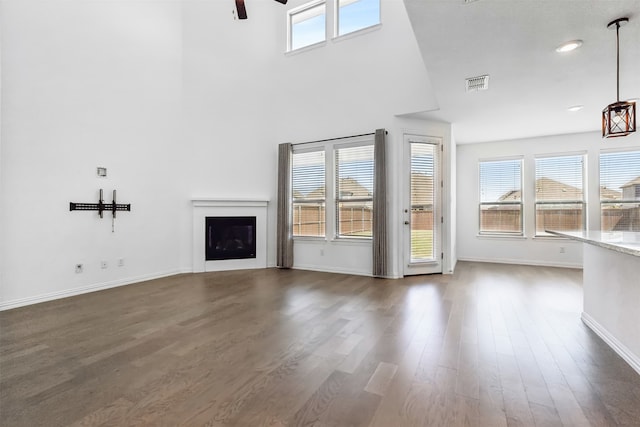 unfurnished living room with hardwood / wood-style floors and a wealth of natural light