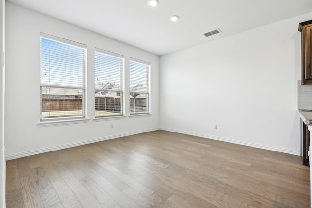 unfurnished dining area featuring hardwood / wood-style flooring