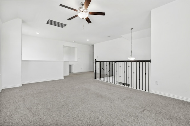 unfurnished room with ceiling fan and light carpet