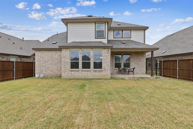 rear view of property with a patio area and a lawn