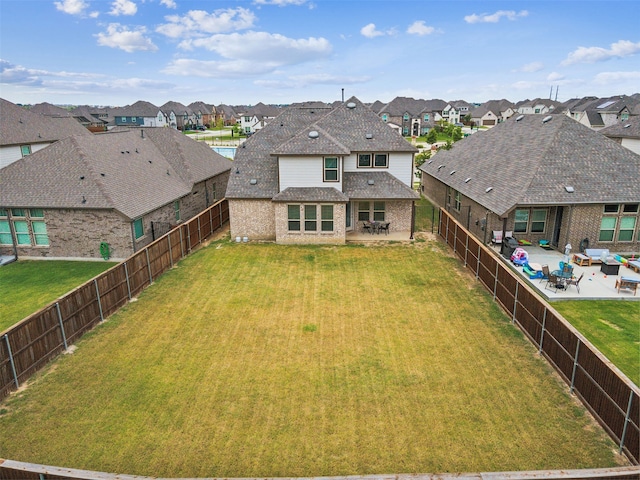 back of property featuring a patio area and a yard