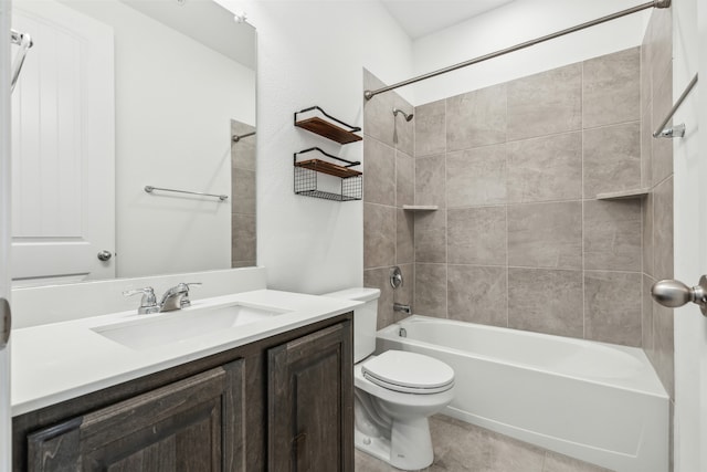 full bathroom featuring toilet, tiled shower / bath combo, vanity, and tile patterned floors