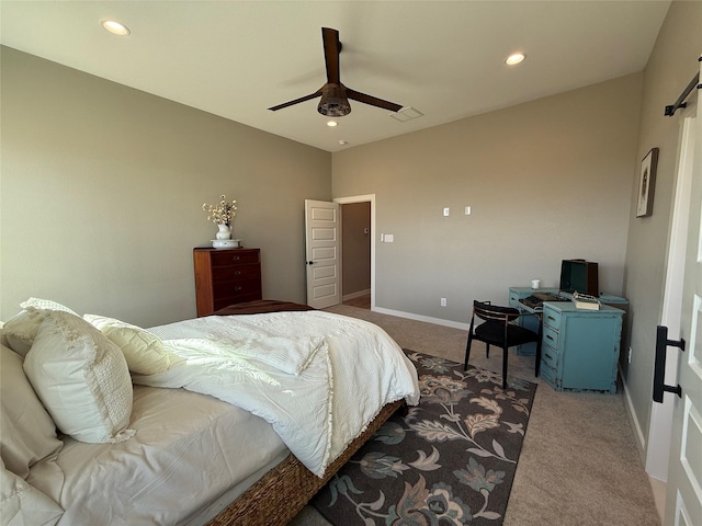 carpeted bedroom featuring a barn door and ceiling fan